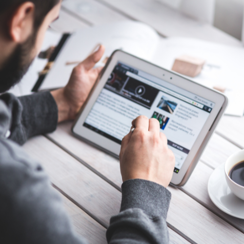 An image of someone reading a newsletter on a tablet.